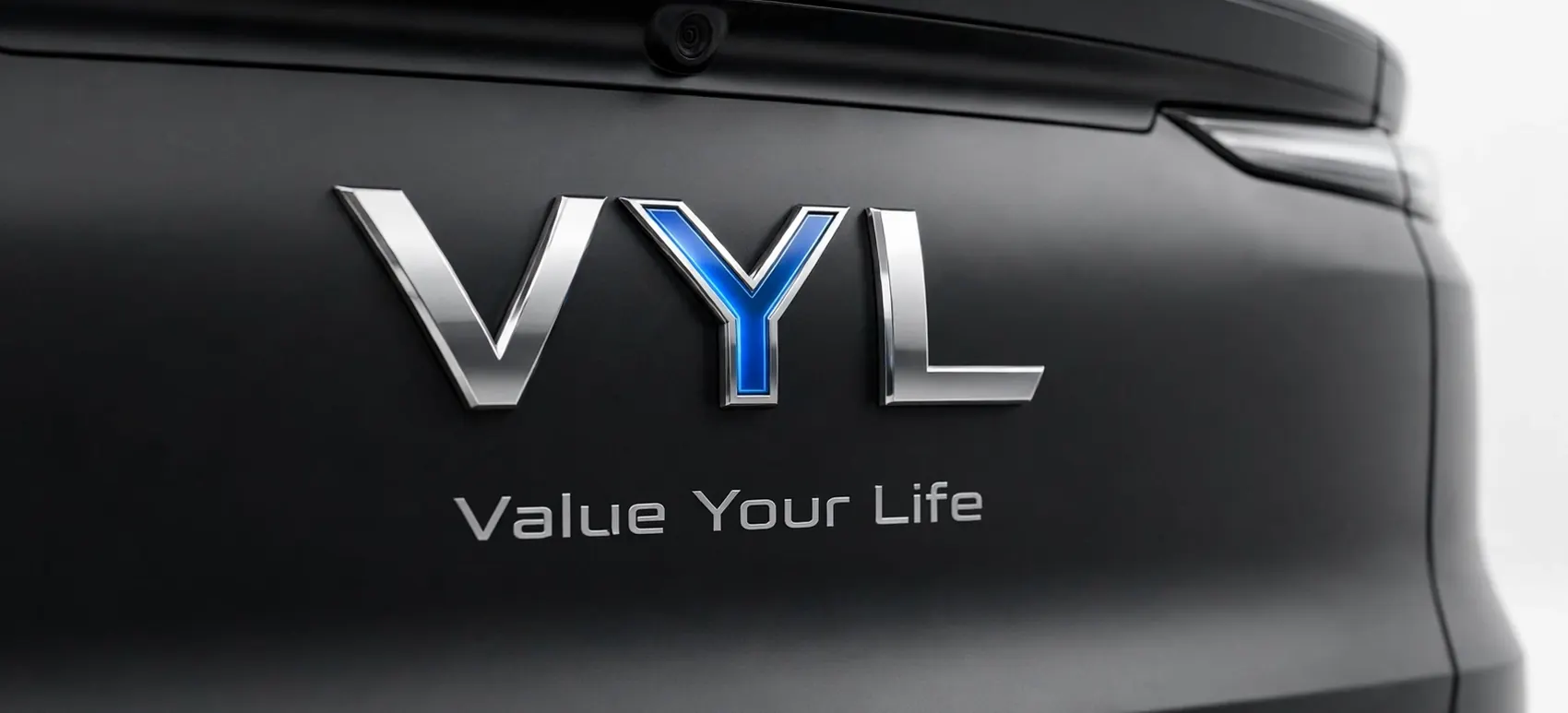 The VYL badge: chrome V and L with an electric blue Y, on a matte black tailgate